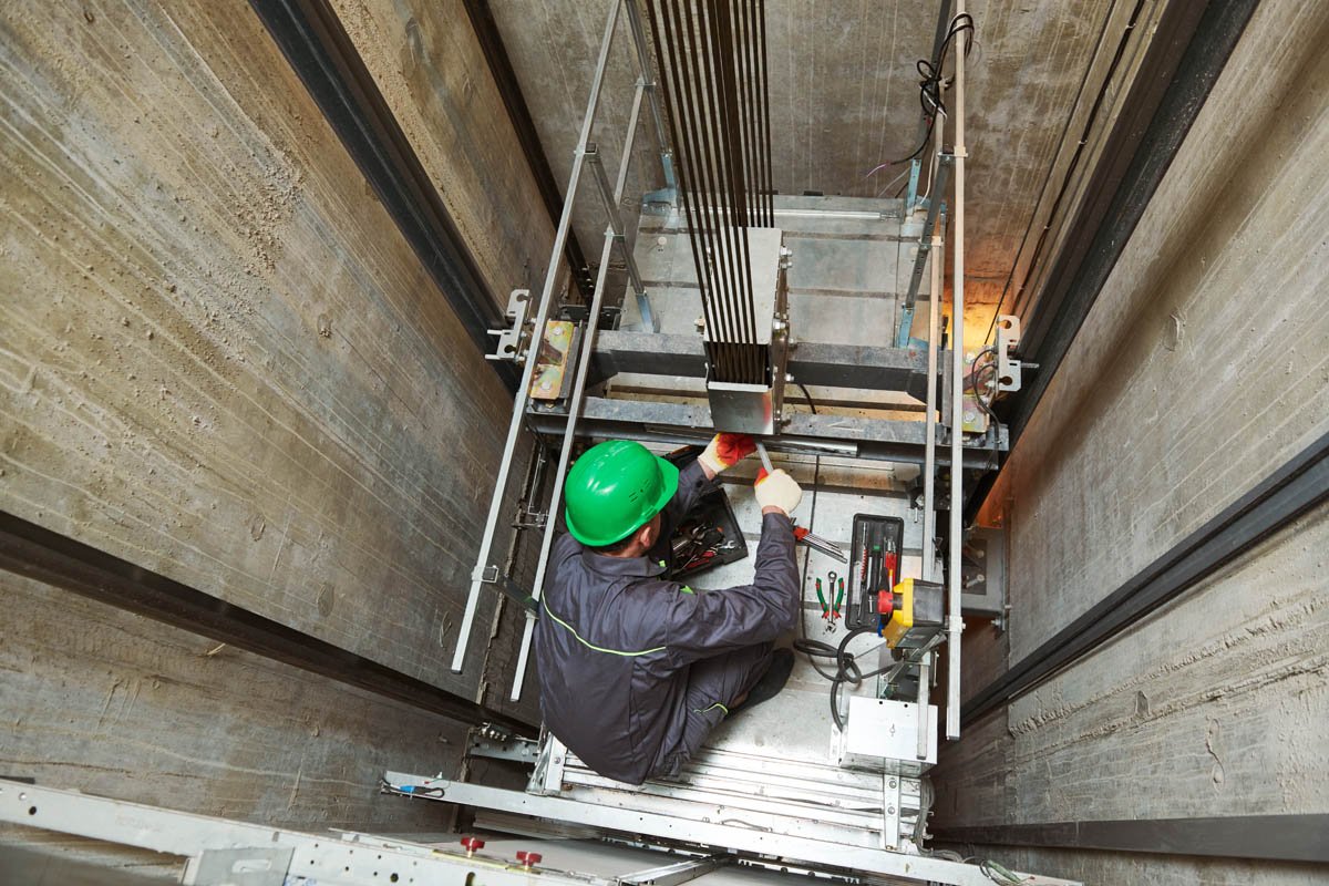 About Ravion lift machinist repairing elevator in lift shaft